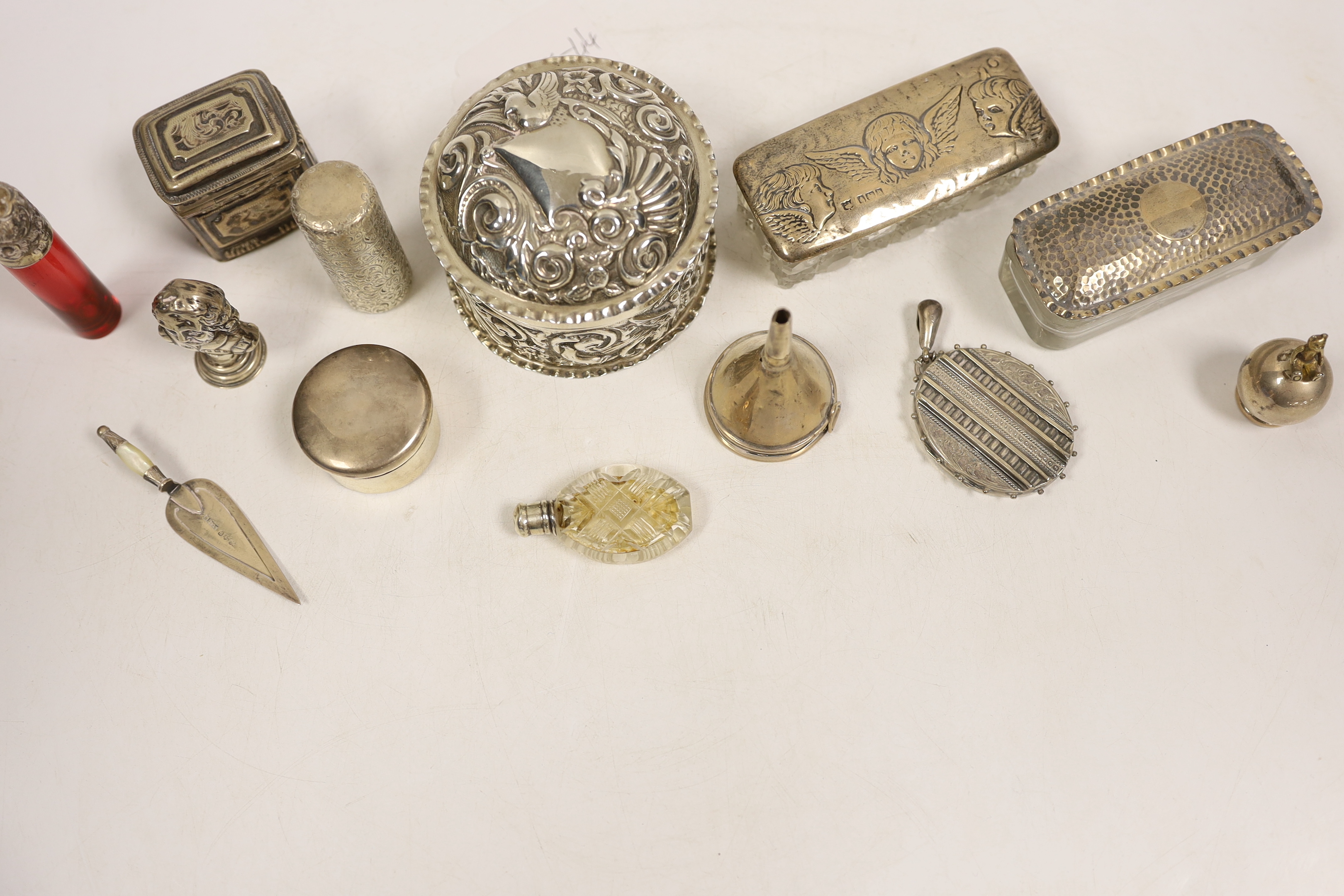 Small silver including two silver mounted glass toilet boxes, a Victorian engraved scent bottle by Sampson Mordan, a perfume funnel, Edwardian Shakespeare bust seal, repousse box and cover, locket, bookmark, etc.